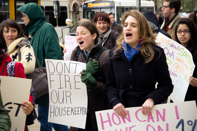 Second-year Allison Fisher (left) and third-year Brita Hofwolt (right) rally in support of housekeeping and dining service employees Thursday afternoon outside the Admin building.