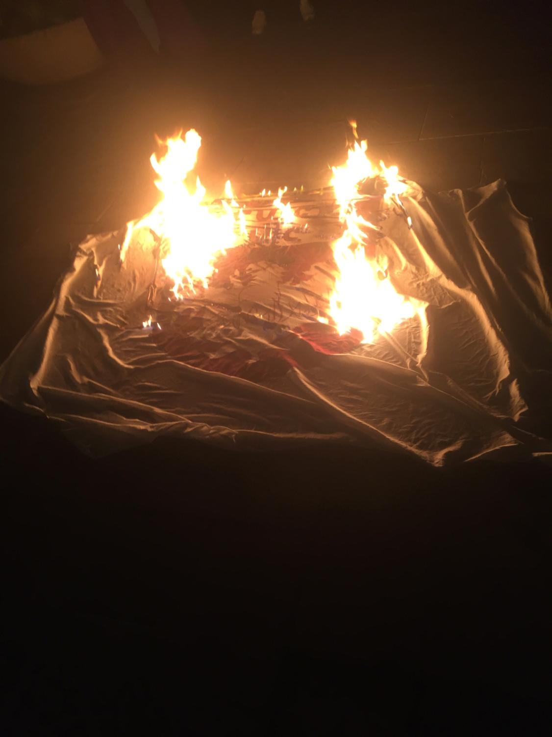 #CareNotCops burned a banner with a UChicago crest on it as part of their Halloween night rally.