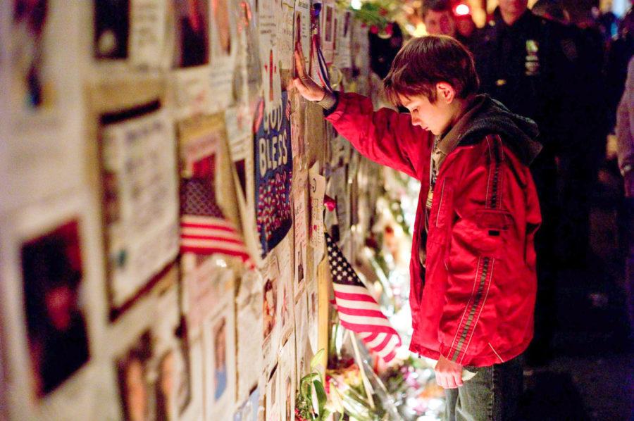Thomas Horn, surrounded by posters of the missing, takes a moment of silence.