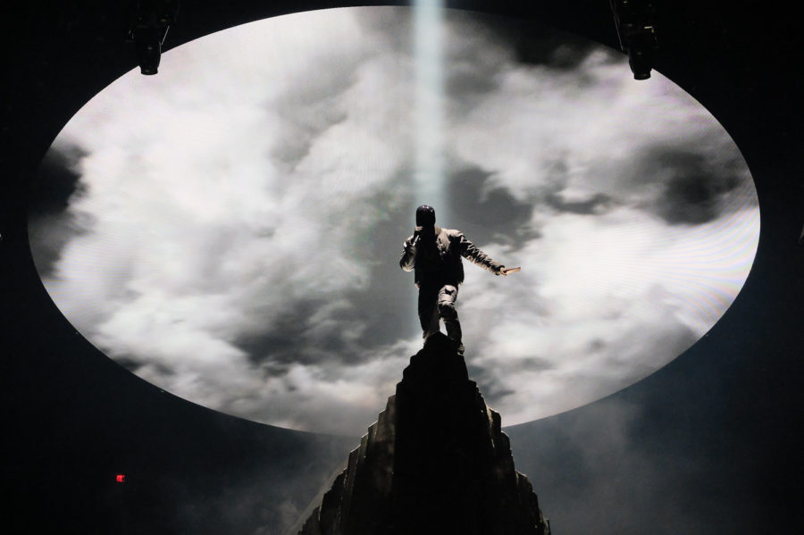 Kanye West, high on the mountaintop in Madison Square Garden. On belay? Belay on. Spotters ready.