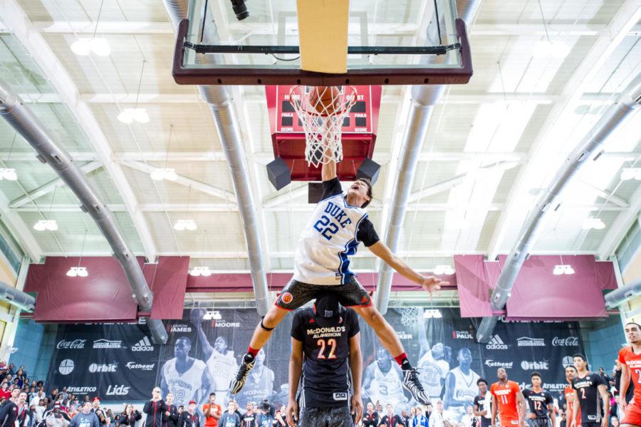 McDonald’s All-American Grayson Allen leaps over 6-foot-10 Jahlil Okafor in the dunk contest portion of the Jam Fest at Ratner last Monday night. 
