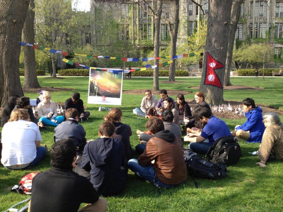 Members of the University community hold a vigil for victims of the Nepalese earthquake on the Main Quad.