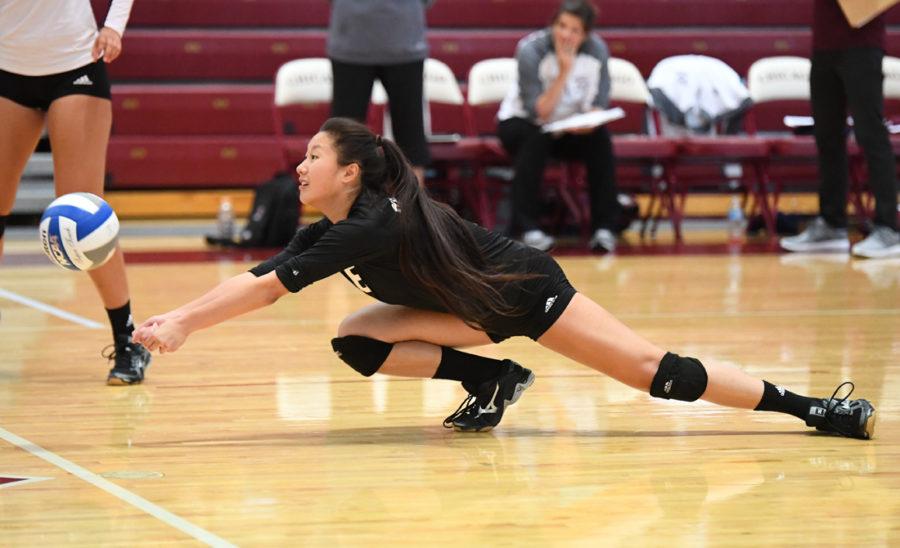 Outside hitter Jessica wang dives for the ball.