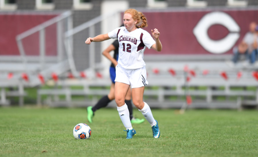 Jenna McKinney makes her mark as she races up the field with the ball in the midst of opposing defenders.