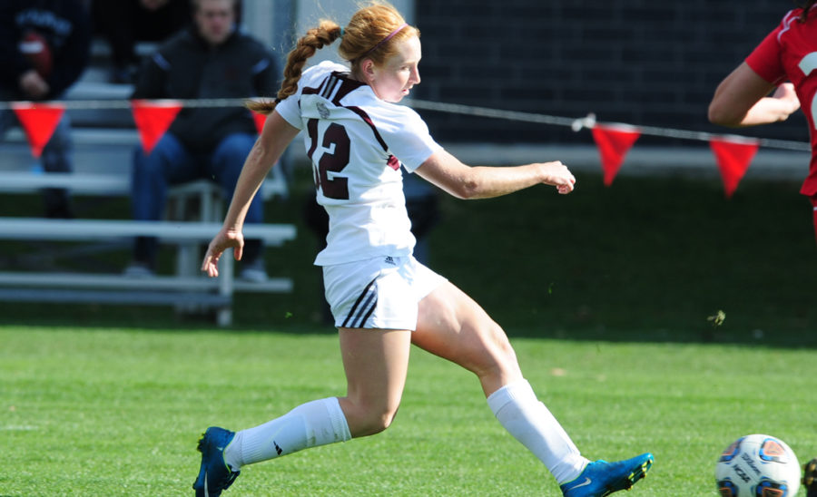 Second-year midfielder Jenna McKinney dribbles the ball past a defender.