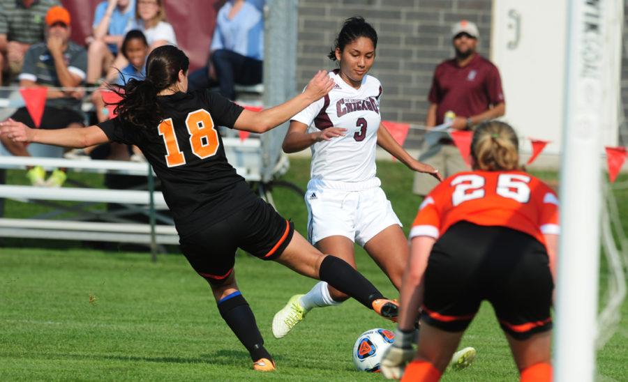 Kelsey Moore avoids a defender as she dribbles up the field.