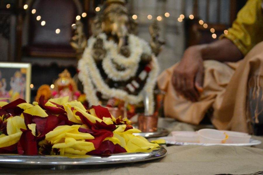 Rose petals are piled on a plate as part of the preparation for the Diwali Puja.