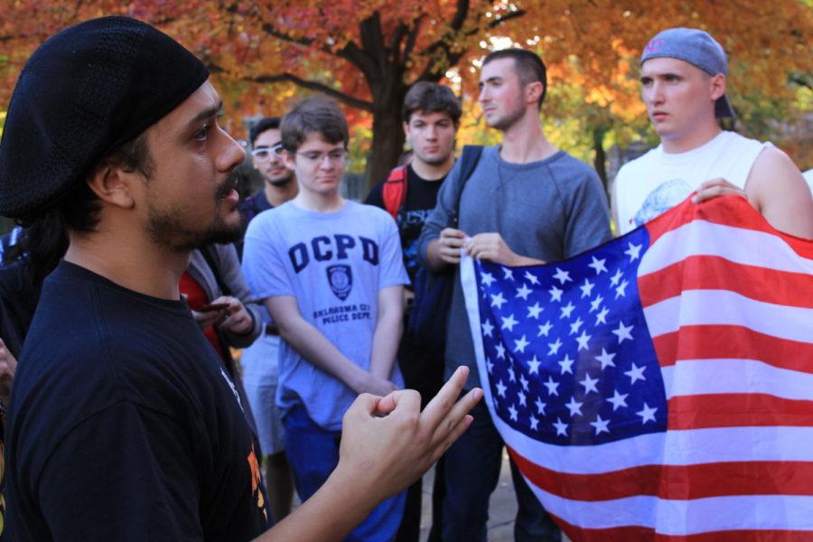 Students hold an American flag while banned Revolutionary Communist Party member Noche Diaz gives a talk on the quad.