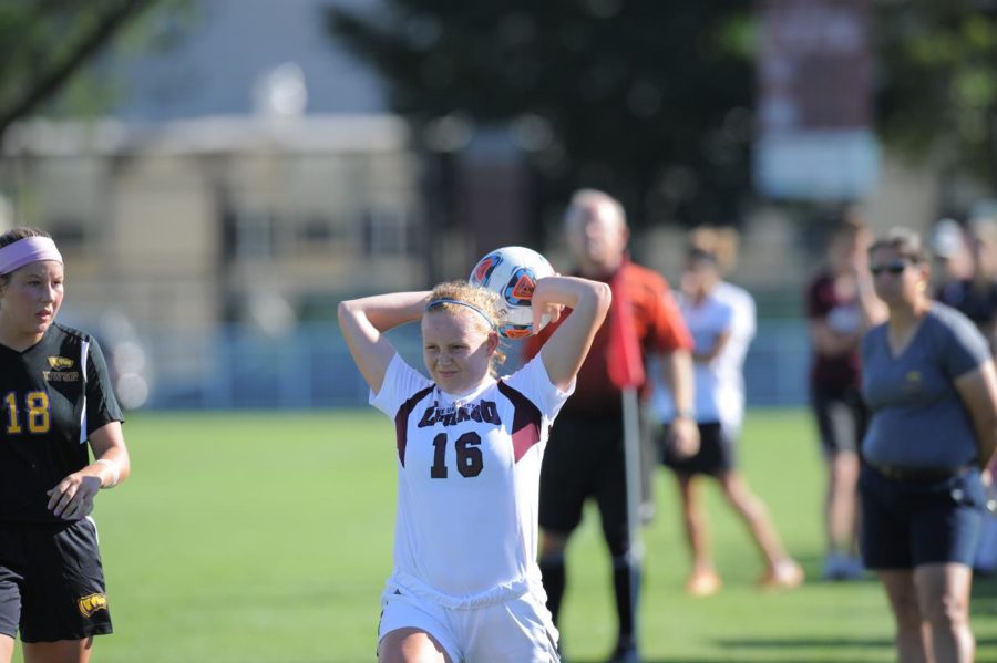 Third-year defender Whitley Cargile throws the ball in to her teammate.