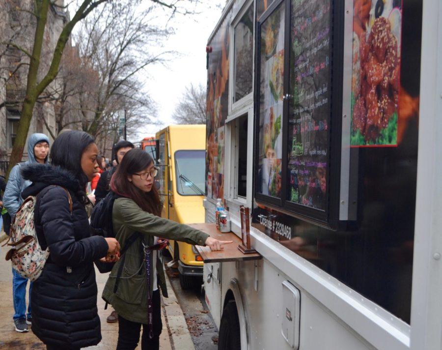 Students line up to buy lunch at a campus food truck.