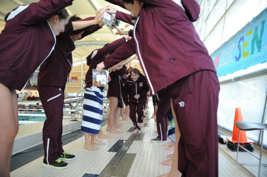 The Maroon swim & dive team gets hyped up for their meet.