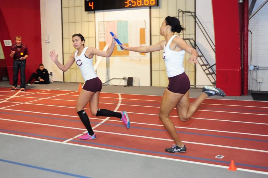 Second-year Alexandra Thompson hands the baton to second-year Nadeen Issa.