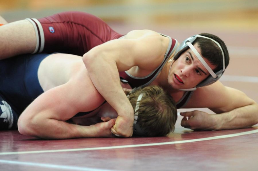 Fourth-year Paul Papoutsis pins down his opponent with intensity.