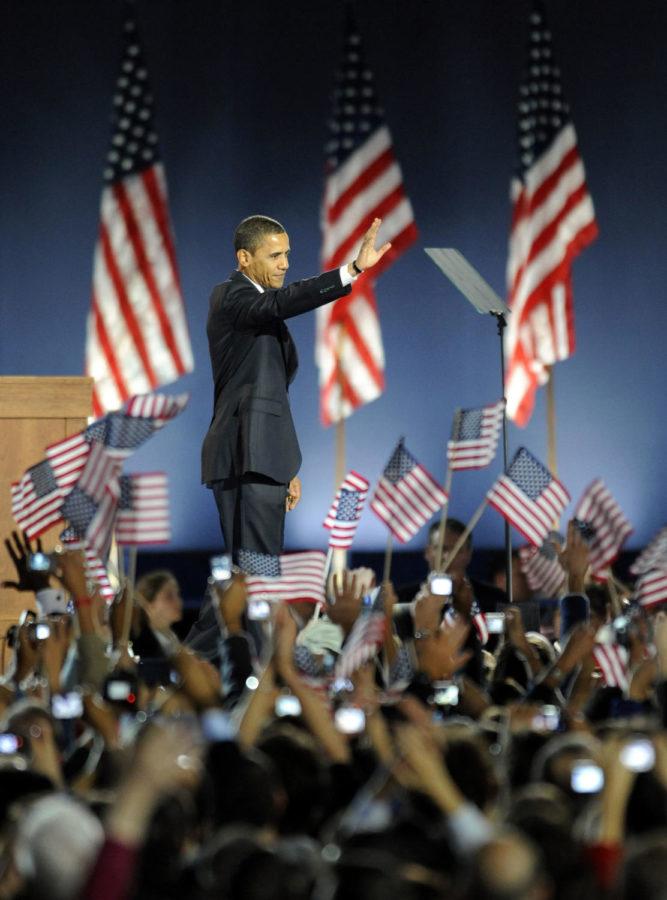 Barack Obama waves to the crowd during his election night victory speech in Chicago.