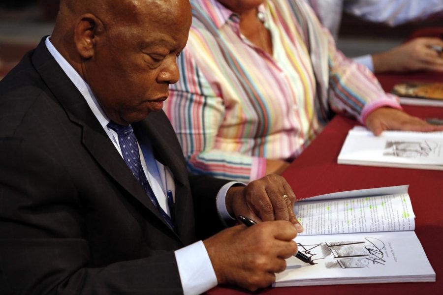 Representative Lewis signing a copy of his new graphic novel.