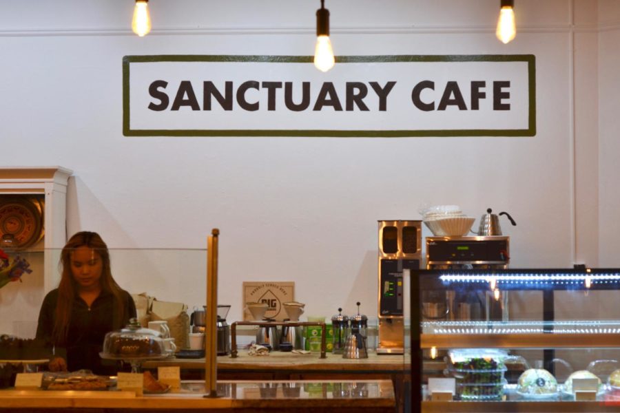 Baristas prepare coffee at the grand opening of Sanctuary Cafe.
