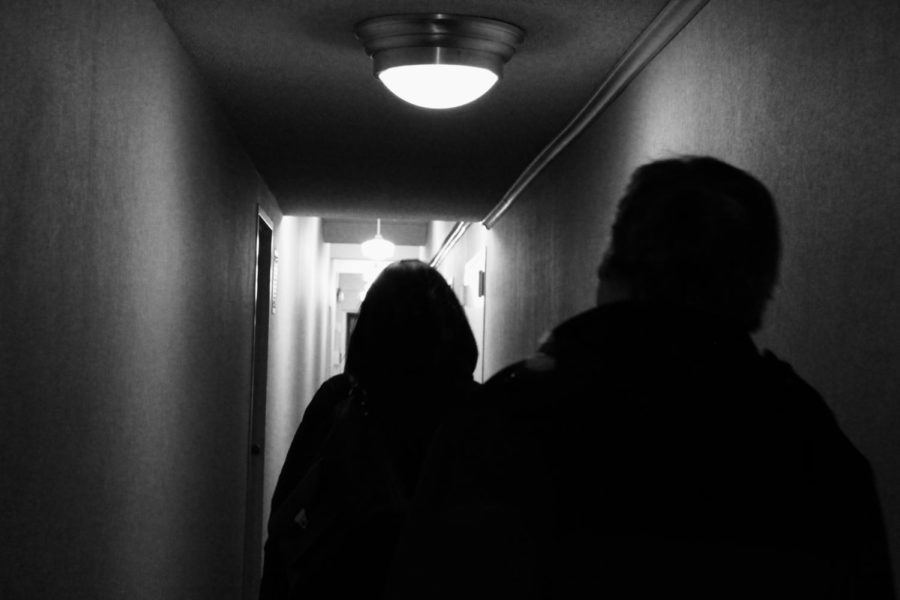 Students in dimly lit hallway.