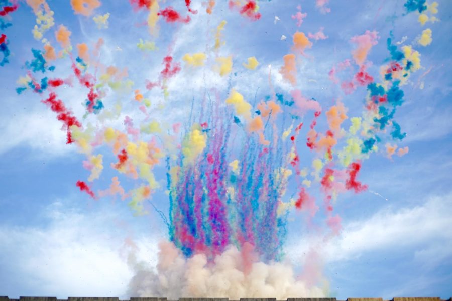 The artwork starts with streaks of color shooting up into the sky.