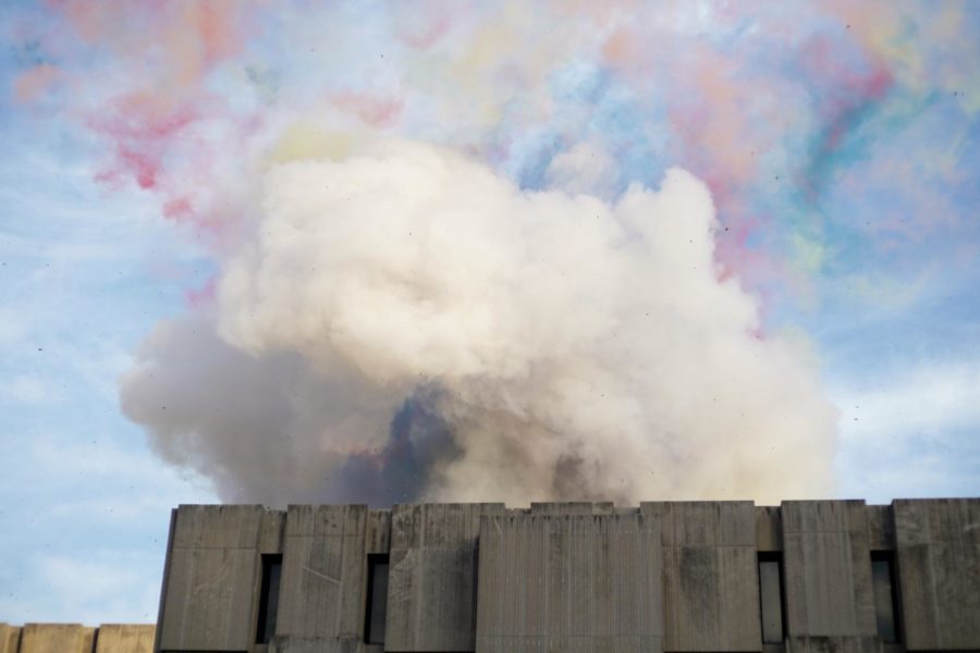 As patches of color slowly dissipate, a light gray mushroom cloud rises from the roof of Regenstein Library.