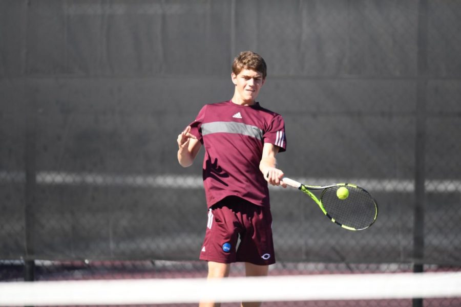 Second-year Tyler Raclin returns the ball with a strong forehand hit.