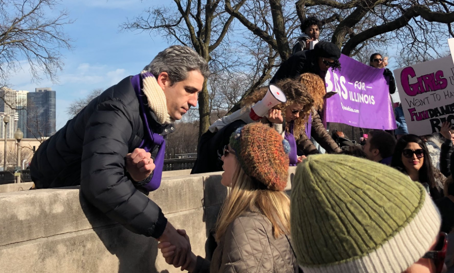 Illinois gubernatorial candidate Daniel Biss (D), a former U of C math professor, shakes hands with supporters at the Chicago Womens March last month.