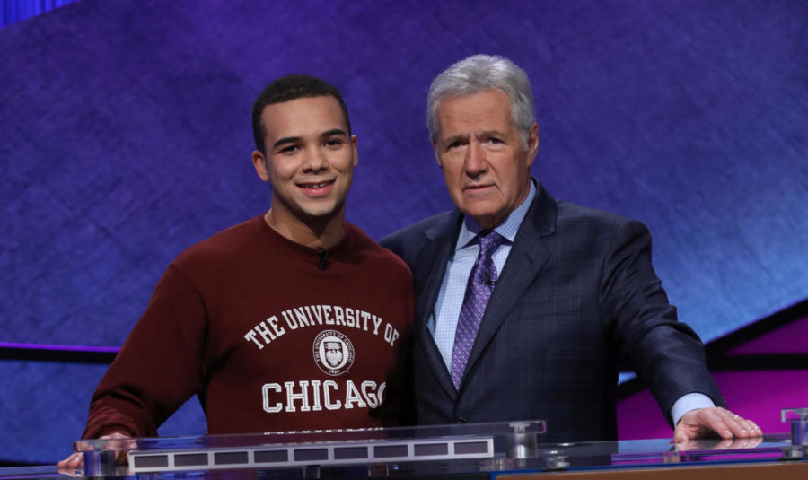 Fourth-year Harry Kioko poses on the Jeopardy! set with host Alex Trebek.
