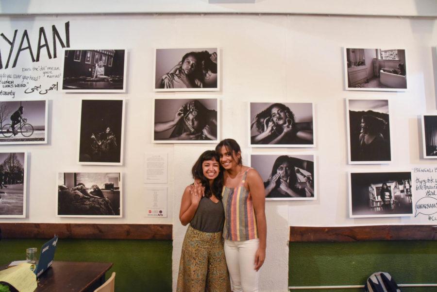 Fatima Khan and Shreya Sood pose next to their artwork.