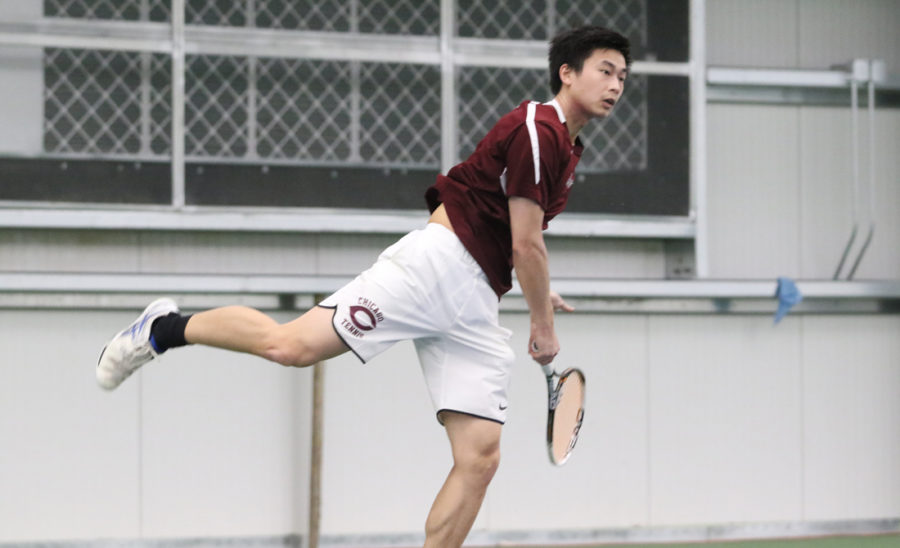 Fourth-year+Luke+Tsai+powerfully+hits+a+forehand+towards+his+opponent.