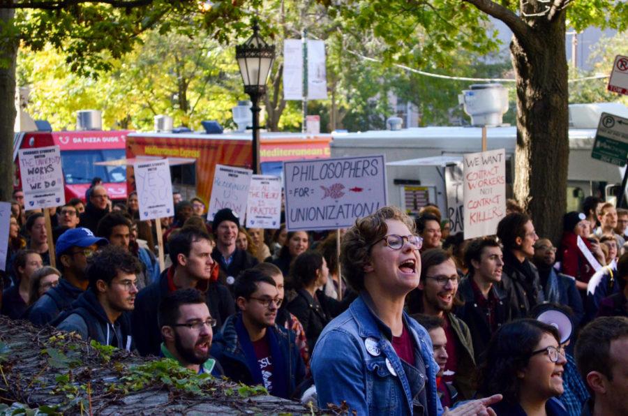 Graduate students chant at a walk out in October, 2018.