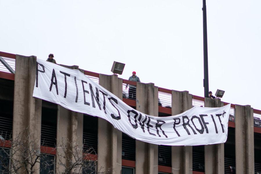 Members of the UChicago Labor Council release a banner at a campus-wide May Day March in 2019