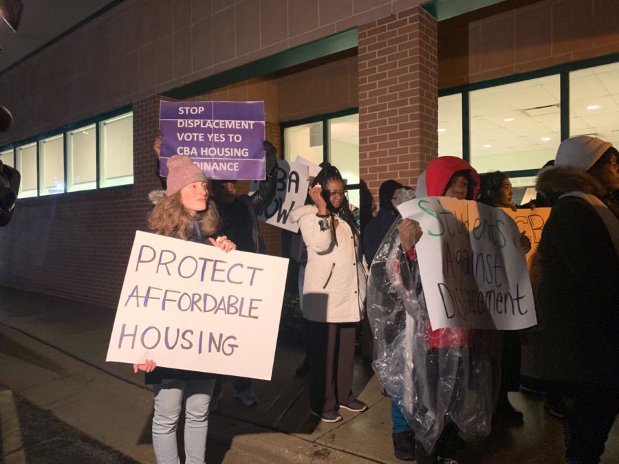 Organizers with the CBA Coalition protest outside a City affordable housing meeting.