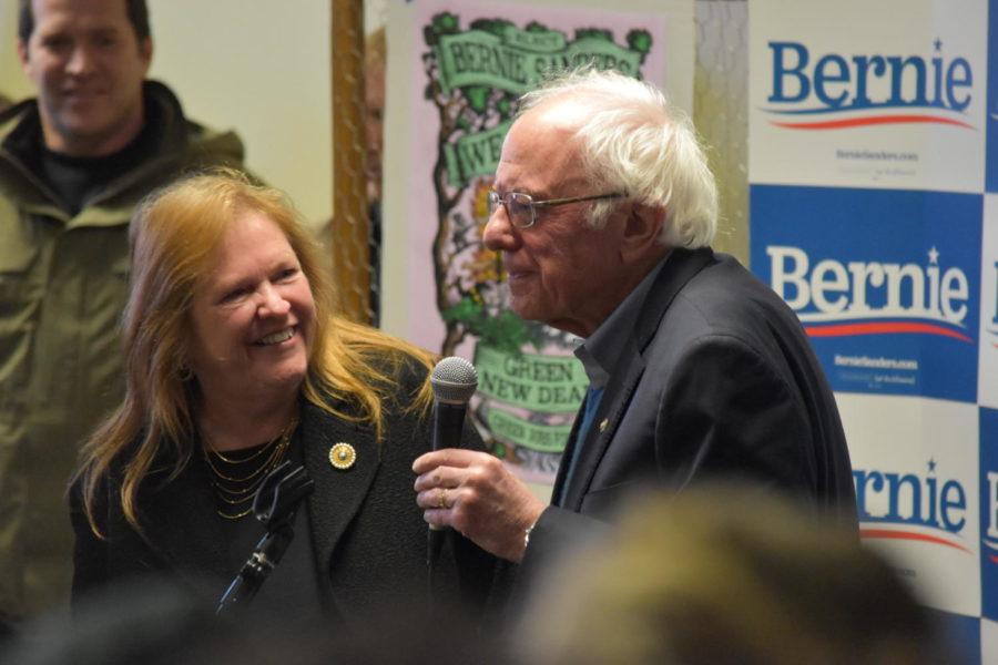 Senator Sanders takes the mic in Iowa City beside his wife, Jane.