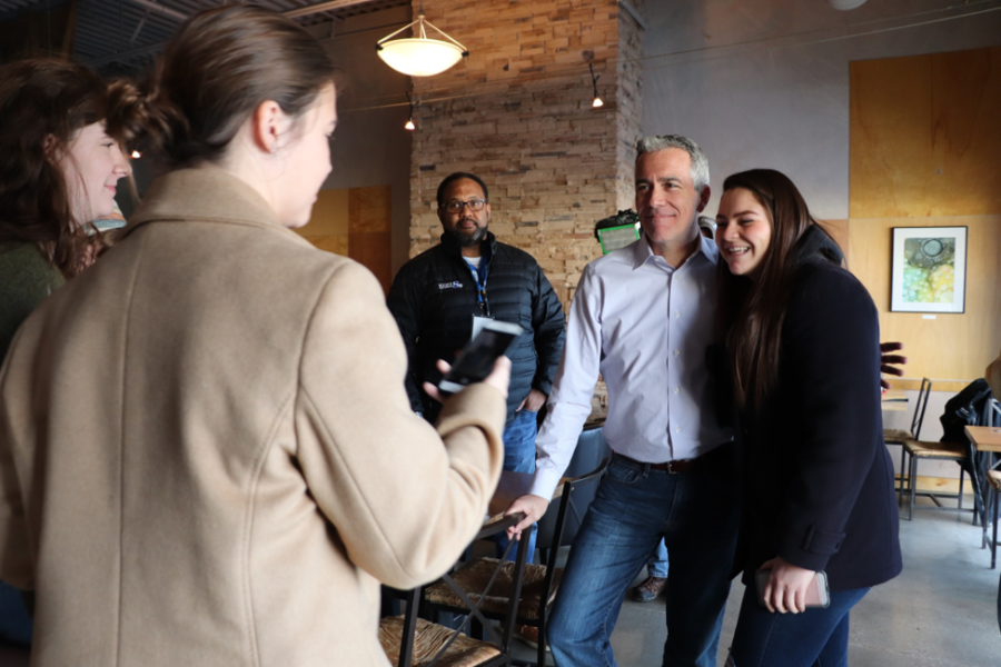 Olivia Ortiz, a Benedictine College student, takes a photo with long-shot Republican challenger Joe Walsh.