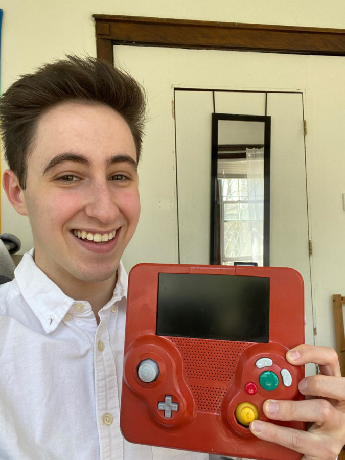 Elliot Kahn holds aloft his homemade GameCube - now abandoned in favor of a (store-bought) Nintendo Switch.