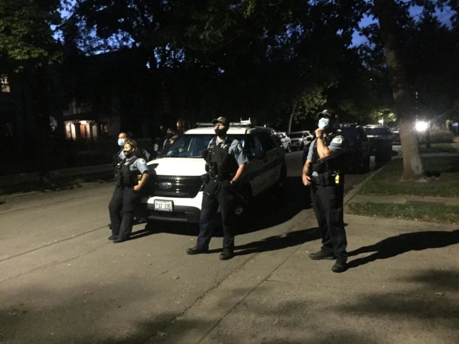 Chicago Police look on at a protest by #CareNotCops in front of Provost Ka-Yee Lees house, September 2020.
