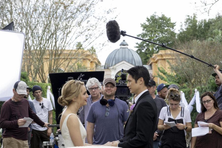 Co-stars Jessica Rothe and Harry Shum Jr. film the wedding scene of All My Life, surrounded by cast and crew.