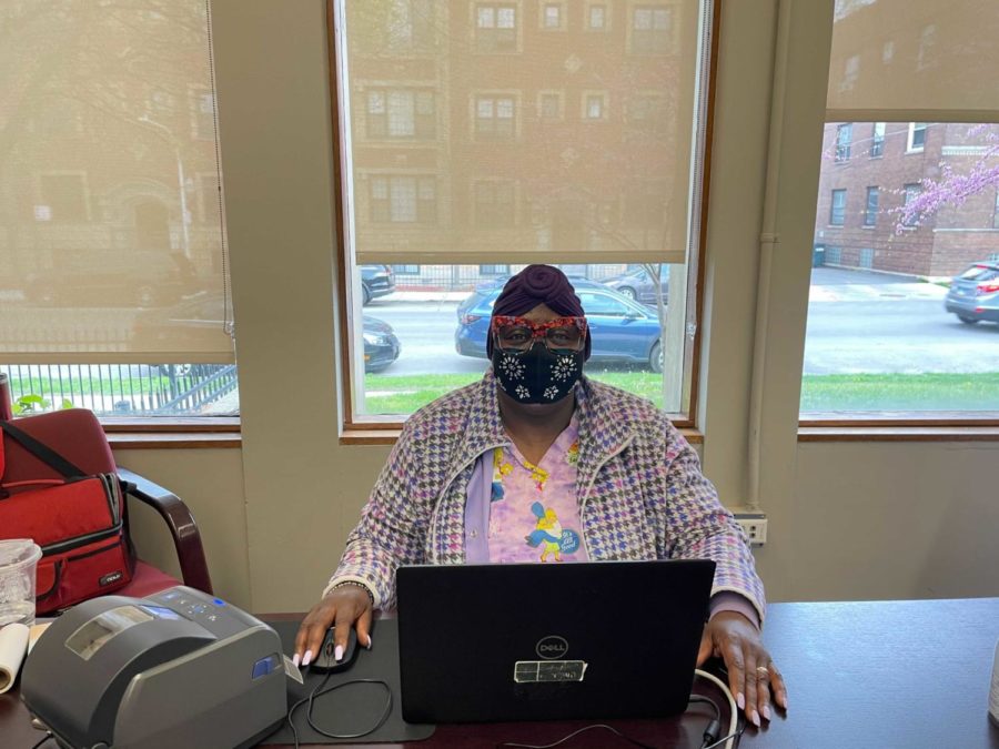 Carrol J. Banks, a coordinator for UChicagos COVID-19 testing program, sits at the check-in desk at the Woodlawn Social Services Center Depot.