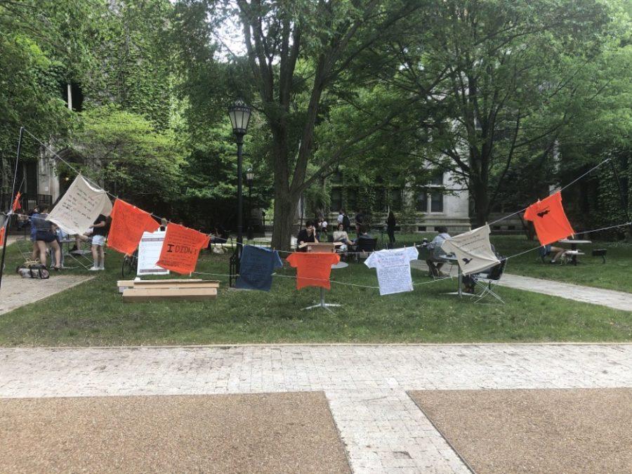 16 T-shirts in various colors hung in the courtyard outside Hutchinson Commons as part of The Clothesline Project.