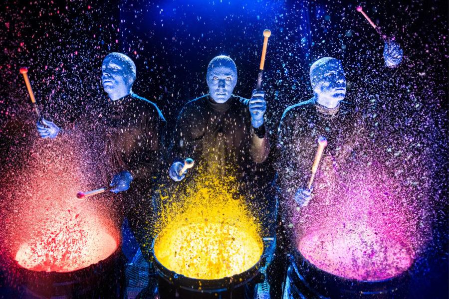 In the opening number, the Blue Men poured glow-in-the-dark paint on large bass drums so that vibrant yellow and pink rocketed upwards with each beat.