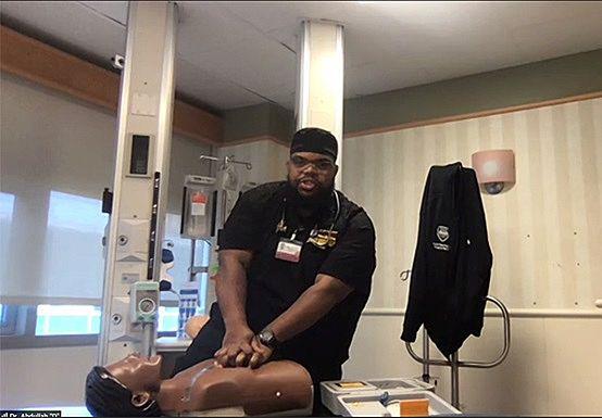 Heart and Vascular Center mentorship program volunteer and emergency medicine physician Abdullah Pratt, MD, demonstrates chest compression during a virtual meeting