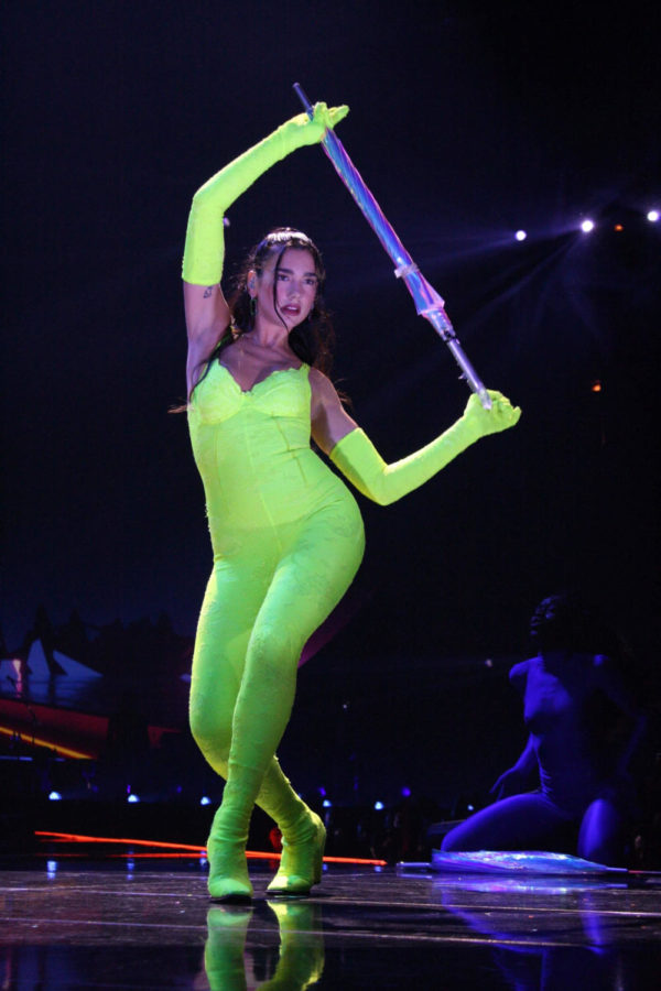 Flanked by her dancers, Lipa emerged in a lime bodysuit with matching gloves.