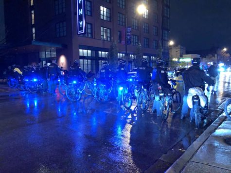 Police form a bicycle line as they corral a group of teens west on 53rd St.