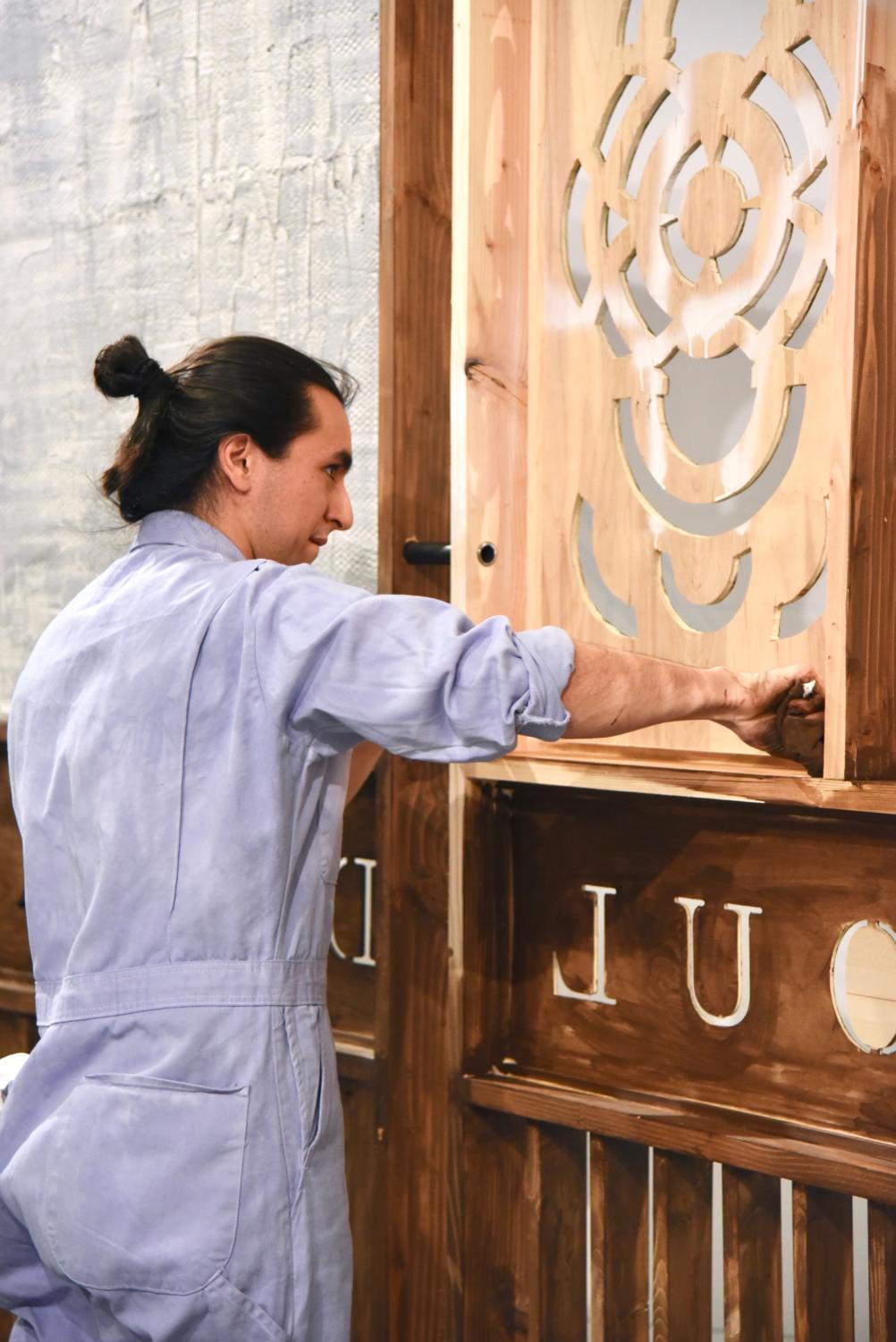 The panels dividing the gallery in half were designed and built by students in the Design Apprenticeship Program, led by Builder Gabe Moreno.