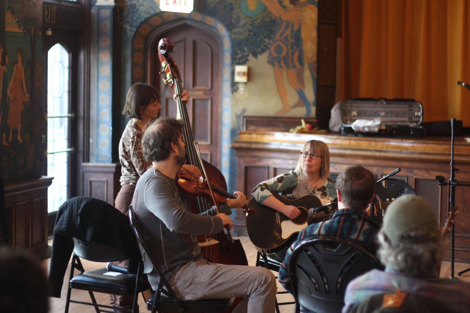 Members of Bigfoot (Rhys Jones on fiddle, Meredith McIntosh on bass, Susie Goehring on guitar) at a workshop in Ida Noyes about playing backup rhythm for old-time music.