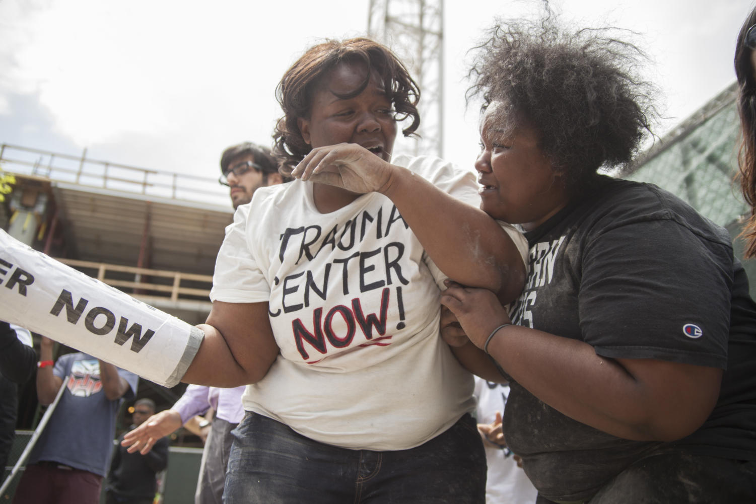 Harris (right) comforts Morris-Moore after she was removed from the premise by UCPD officers. Morris-Moore said that she could not feel her encased hand and was taken to the emergency room by ambulance.