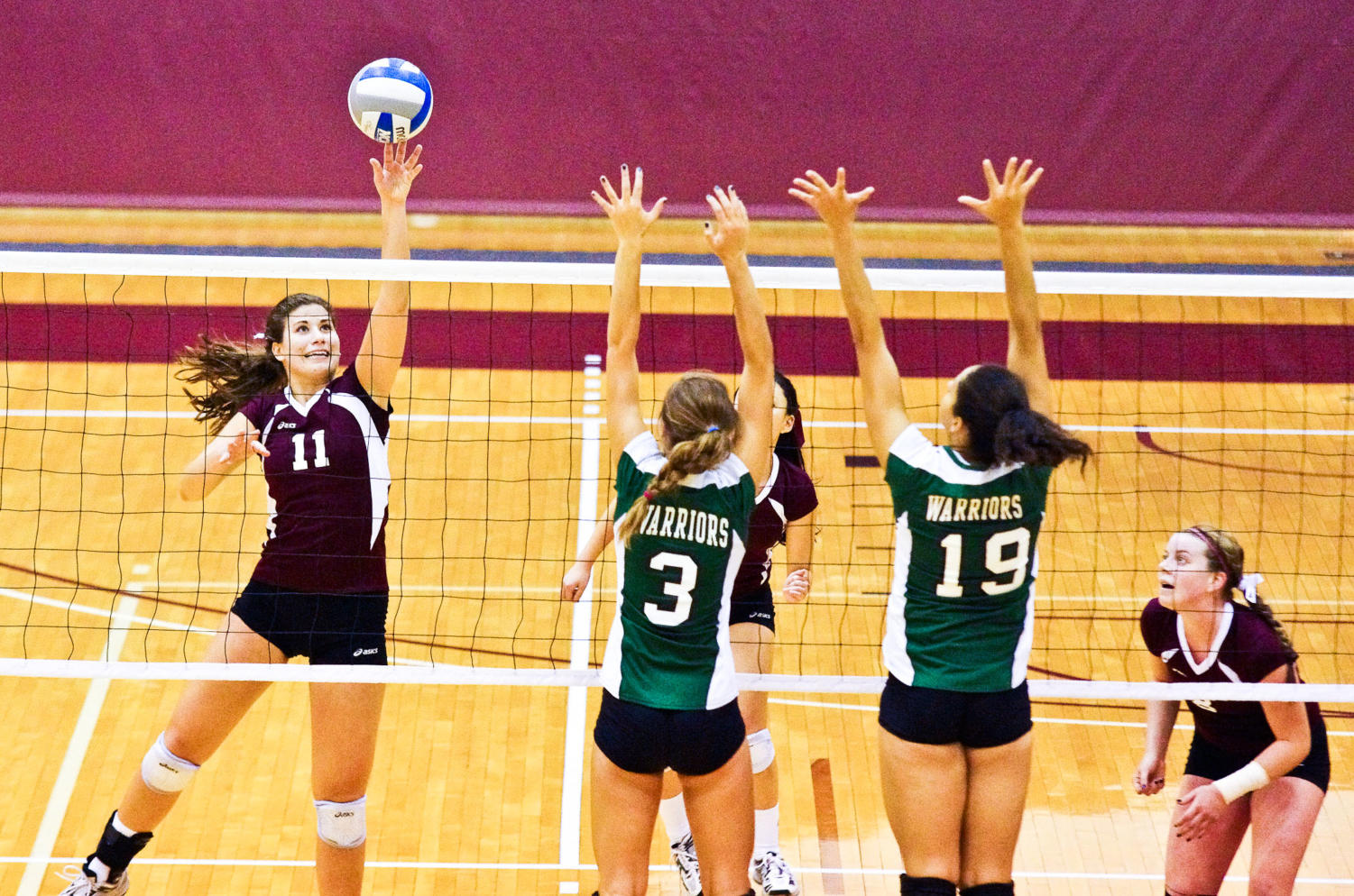 Fourth year Colleen Belak tips the ball over the net during a game against Wisconsin Lutheran.