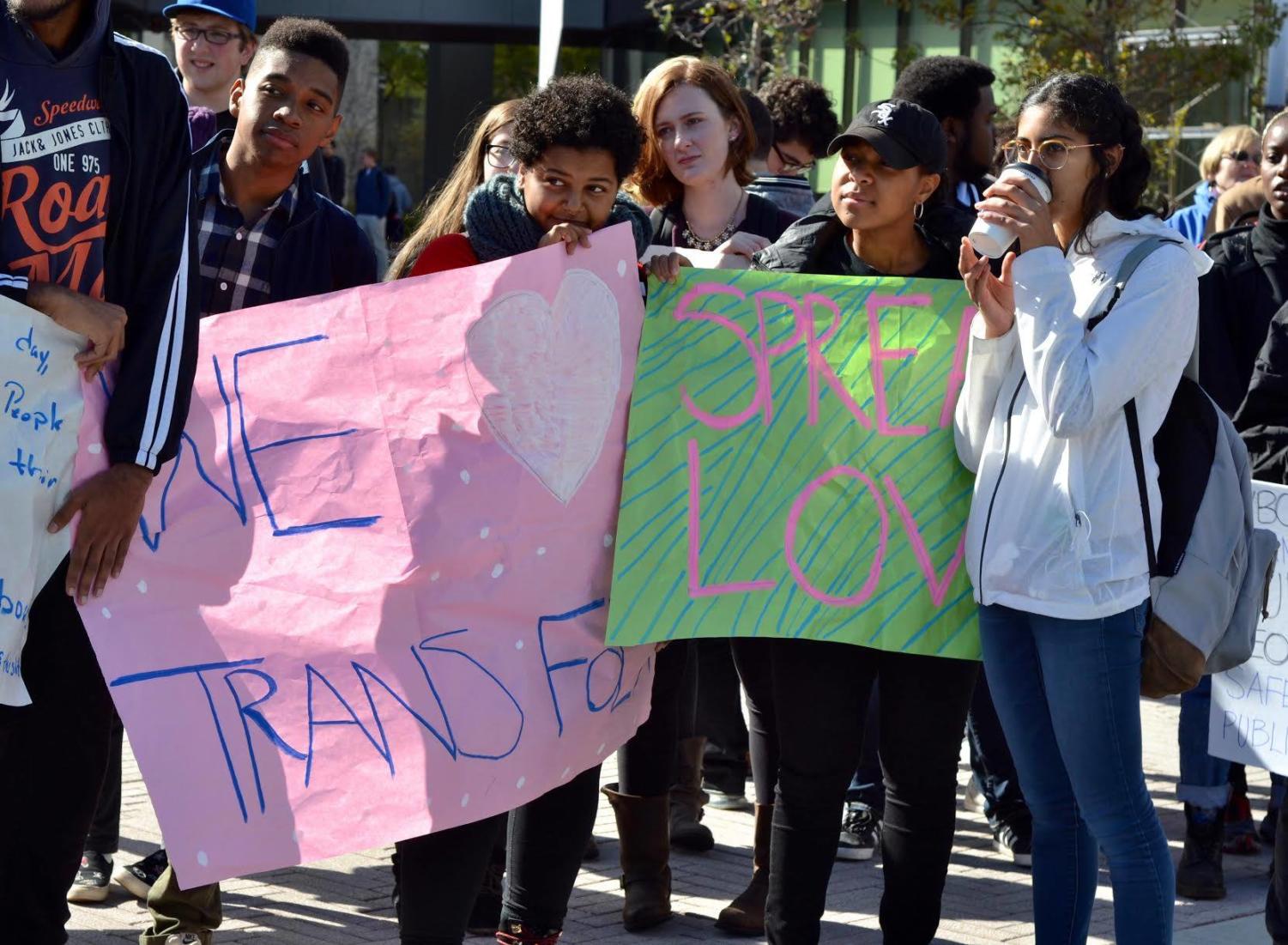 Students huddle in front of Campus North holding signs to counterprotest the Westboro Church picket.
