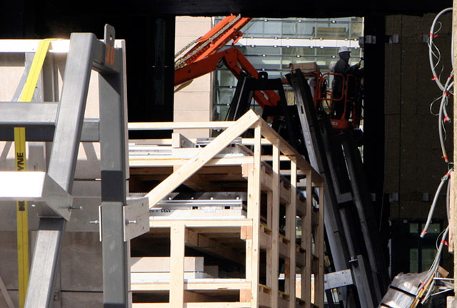 A construction worker examines the frame on a courtyard facing wall inside the new dormitory.