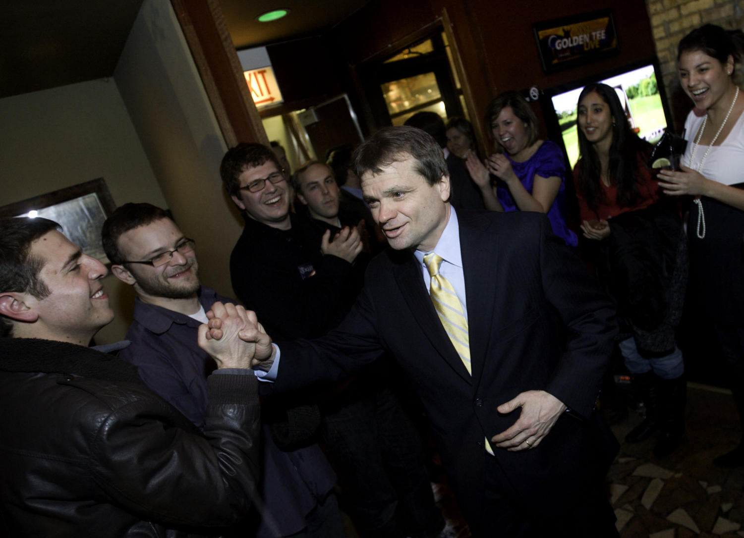 Mike Quigley enters the Wrigleyville brewery Red Ivy to deliver his victory speech.