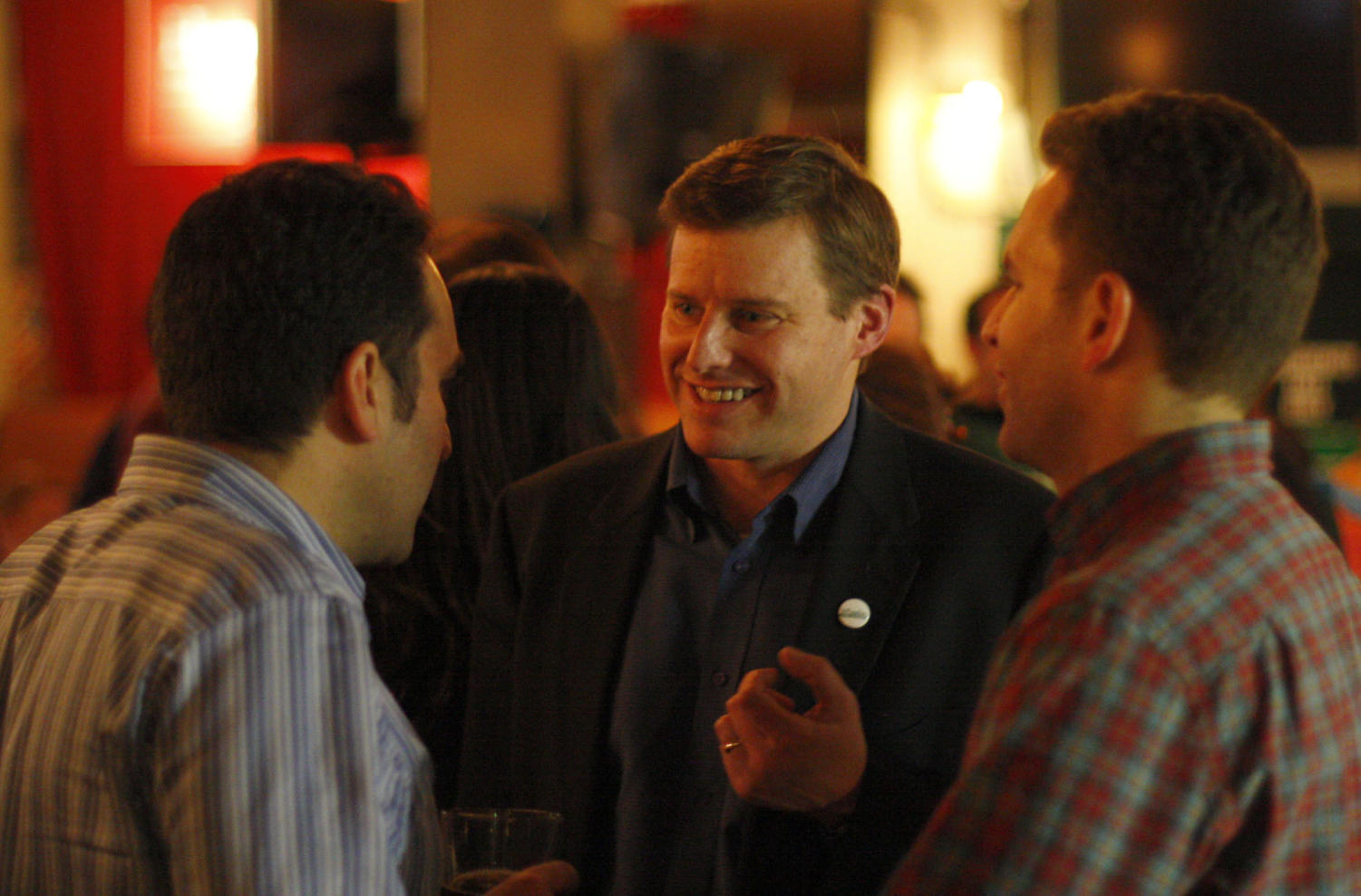 Charles Wheelan, professor at the Harris School of Public Policy, speaks with two supporters on the night of the Illinois's 5th Congressional District Democratic primary Tuesday. Later in the night, Wheelan conceded at the Goose Island Brewery in front of family, friends, and supporters.